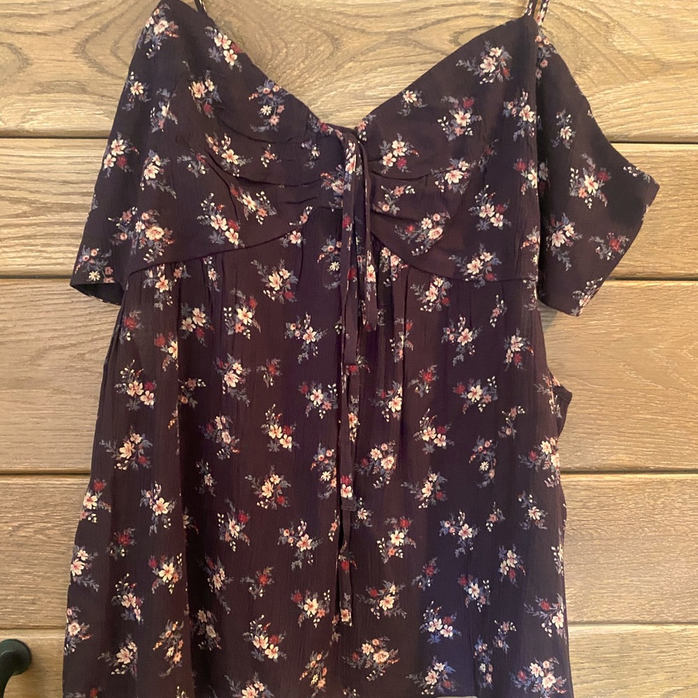Floral tank with cut outs on the sides. Brand new with tag.